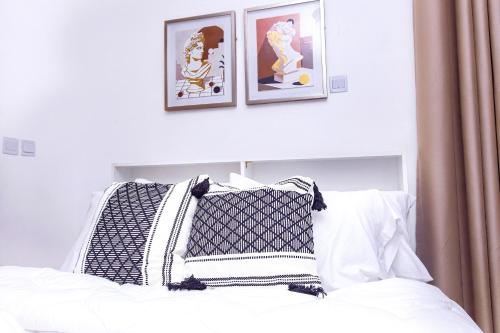 特马AZURE - the perfect escape的一张配有黑白枕头和框架照片的床