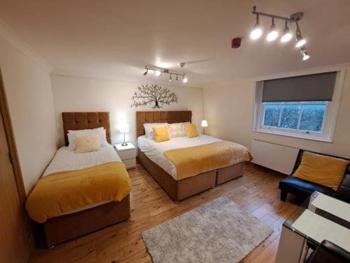 伦敦Angel x Kings Cross Hub的一间卧室设有两张床和窗户。