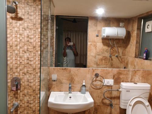 苏拉特Rajhans Belliza Aashiana的一个人拍着带镜子的浴室的照片