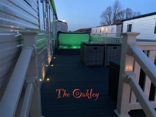 塔特舍尔Tattershall Lakes The Oakley Caravan 8 berth with Hot tub & WiFi的一个带乒乓球桌和灯的甲板