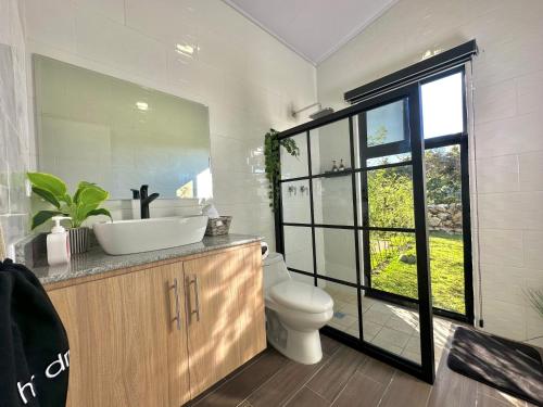 Alto BoqueteCabañas y suites Sunset的一间带水槽和卫生间的浴室以及窗户。