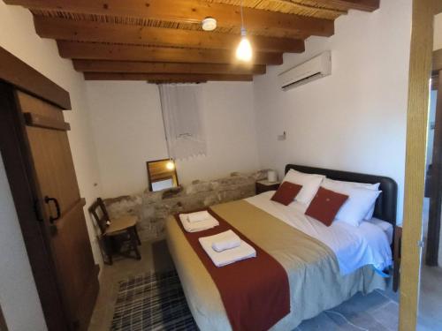 Kallepia阿格罗蒂克传统民居酒店的一间卧室配有一张大床和毛巾