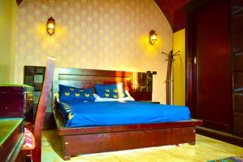 阿布辛贝Kony Nubian Guest House的一间卧室配有一张带蓝色床单和蓝色枕头的床。