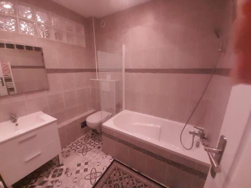 塞纳河畔皮埃尔菲特5 Rue Adeline的带浴缸、卫生间和盥洗盆的浴室
