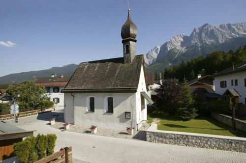 格赖瑙Ferienwohnung Bergspitz的村庄中一座小白色教堂