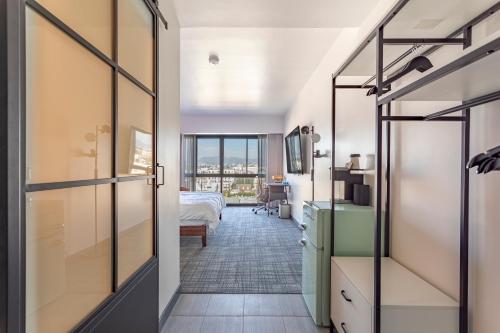 洛杉矶Hotel Koxie的走廊上设有一间卧室,卧室内配有一张床和一个窗户