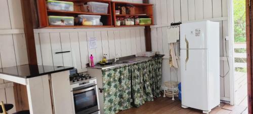 阿居鲁特乌亚Casa de Praia - Ajuruteua Pará的厨房配有炉灶和冰箱。