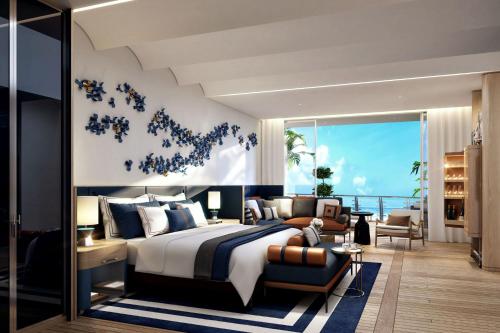 马斯喀特The St Regis Al Mouj Muscat Resort的一间带大床的卧室和一间客厅