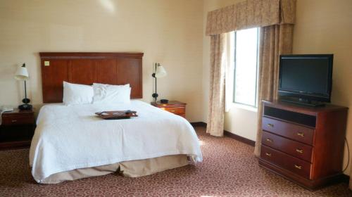 金曼汉普顿金曼套房酒店的酒店客房,配有床和电视