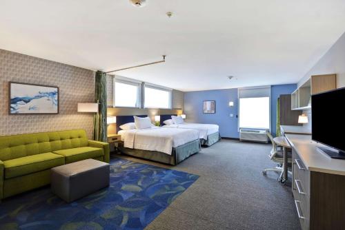 大急流城Home2 Suites By Hilton Grand Rapids North的酒店客房,配有床和沙发