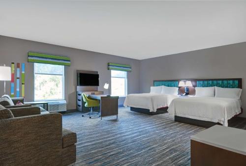 MacclennyHampton Inn And Suites Macclenny I-10的酒店客房设有两张床和电视。