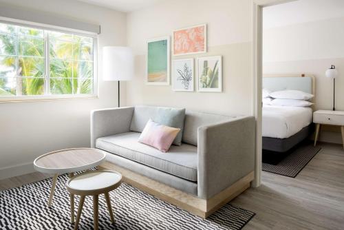 乔治敦Hampton by Hilton Grand Cayman Seven Mile Beach的客厅配有沙发和1张床