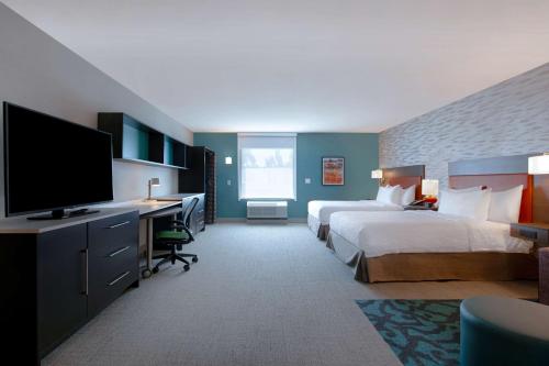 费耶特维尔Home2 Suites By Hilton Fayetteville North的酒店客房设有两张床和一台平面电视。
