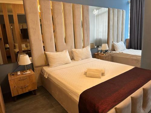 安塔利亚Grand Niki Hotel & Spa的一间卧室配有一张大床和两盏灯