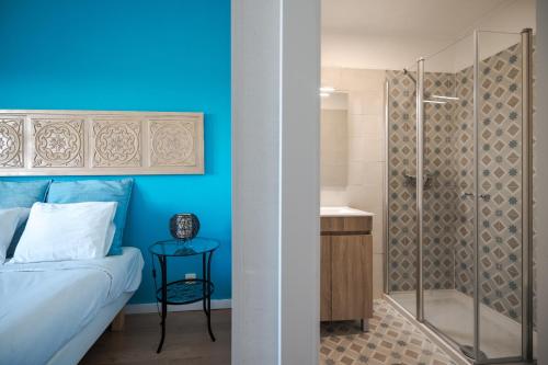 埃里塞拉Casa da Ribeira Quarto Turquesa的蓝色卧室配有一张床和淋浴