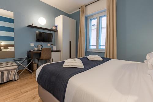 斯培西亚拉洛贾德班驰旅馆的一间卧室配有一张床、一张书桌和一台电视