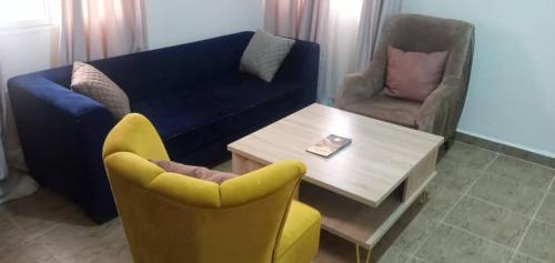 JiruBenji Apartments的客厅配有沙发和桌椅