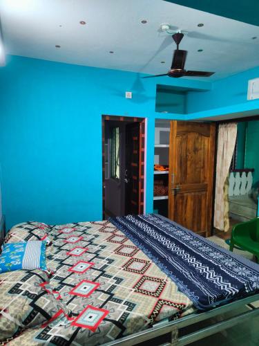 普里jharana guest house的一间卧室配有一张蓝色墙壁的床