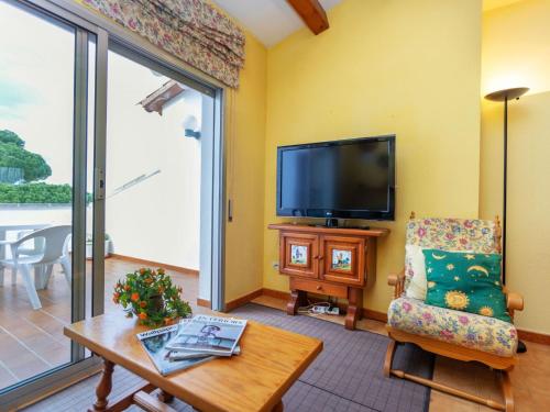 莱斯卡拉Apartment Residencial Gran Sol by Interhome的客厅配有电视、椅子和桌子