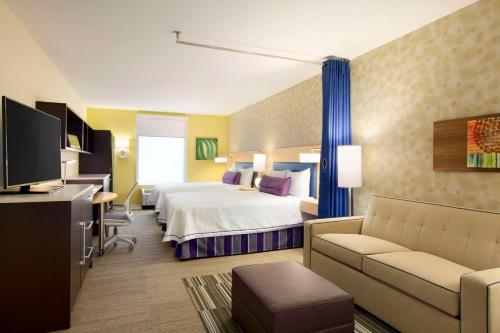 休斯顿Home2 Suites by Hilton Houston Energy Corridor的酒店客房,配有床和沙发