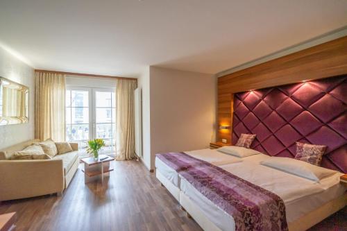 宾茨Arkona Strandresidenzen的酒店客房设有一张大床和一张沙发。