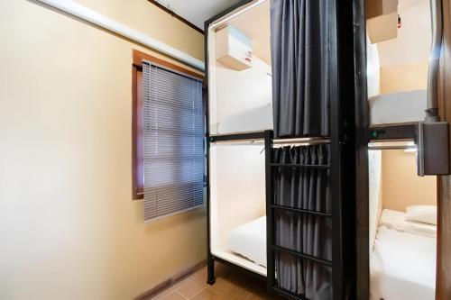 清迈Cozy Hub Hostel的客房设有两张双层床和一扇窗户。