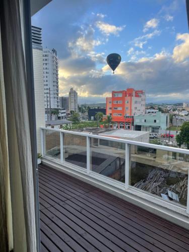 托雷斯Apto duplex Lagoa do Violão的空中热气球从阳台上飞过城市
