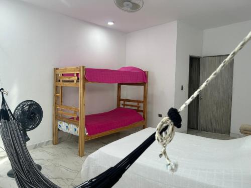 Puerto EscondidoCabaña Maríamar2的一间卧室配有一张床和一张红色椅子