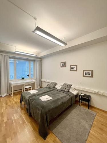 赫尔辛基Kotimaailma Apartments Kamppi - 1BR for 3 persons的一间卧室设有一张大床和一个大窗户