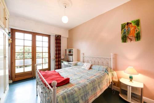 波尔多appartement bordeaux的一间卧室配有一张床铺,床上铺有红色毯子