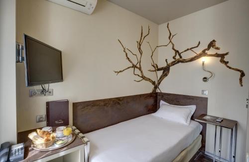 皮托维瓦尔第酒店的卧室配有一张床铺,墙上挂着一棵树