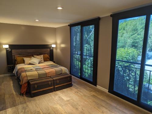 圣卡洛斯-德巴里洛切Citizen Kane Lodge - Hospedaje Gourmet的一间卧室设有一张床和大窗户