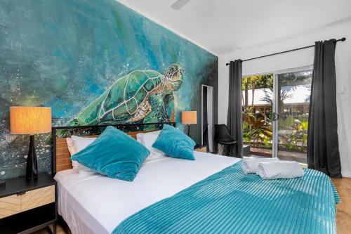 棕榈湾棕榈湾棕榈树度假屋的卧室的墙上挂有海龟画