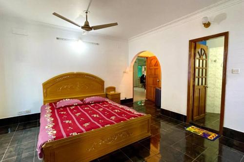 巴纳内拉斯Kumar Para Deluxe Villa的一间卧室配有一张带红色毯子的床