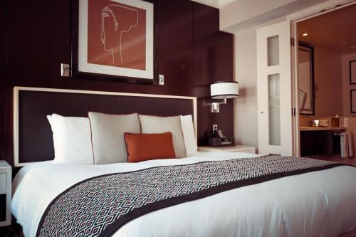 贾夫纳Suguna Villa的酒店客房带一张大床,带白色床单