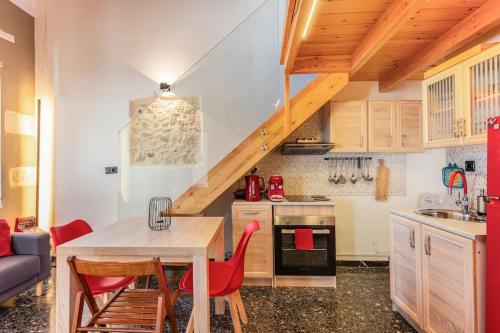 罗希姆诺Arcade central retro apartment的厨房配有木桌和红色椅子