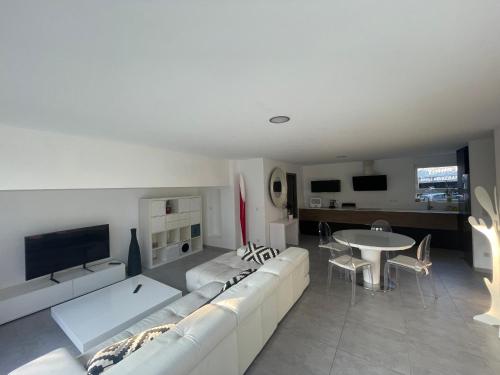 利戈尔塞姆Villa plein pied的客厅配有白色的沙发和桌子