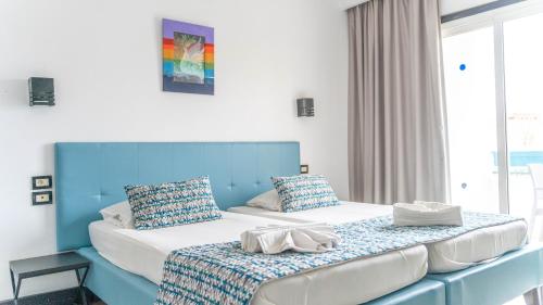 苏塞HOTEL KAISER的蓝色和白色的客房内的两张床