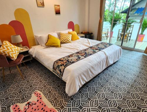象岛Easy Life Koh Chang的一间卧室配有一张带黄色枕头的大床