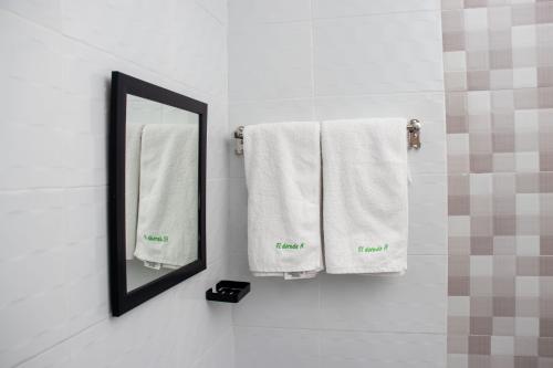 纳库鲁Eldorado Rustic Hotel的浴室提供白色毛巾和镜子