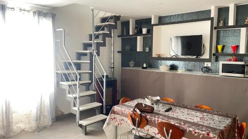 蒙德拉戈内La Maison2的客厅设有楼梯和桌子