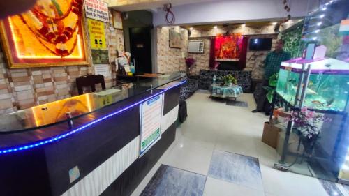 巴特那Goroomgo Mayagiri Patna的一间带酒吧的餐厅,内设一个鱼缸