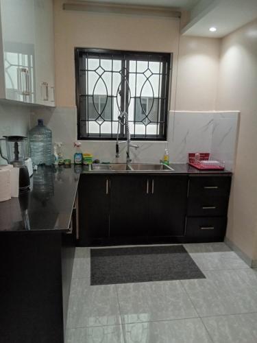 坎帕拉SHOAL Apartments, Mawanda Road的厨房设有水槽和窗户。