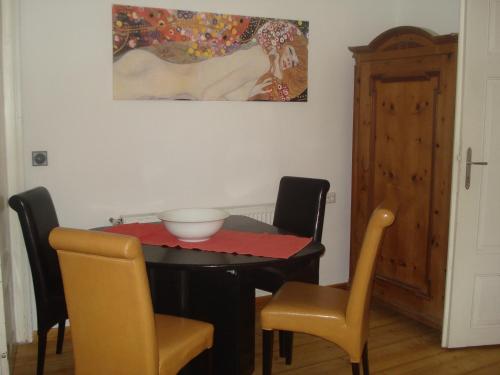 昂特保科洛佩因兰德佛尔克公寓的餐桌、椅子和墙上的绘画