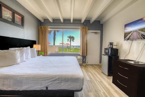 代托纳海滩海滨别墅酒店的一间卧室配有一张床,享有海滩美景