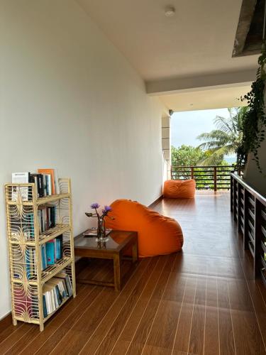 米瑞莎MIRISSA Reef Serenity的客厅配有橙色沙发和书架