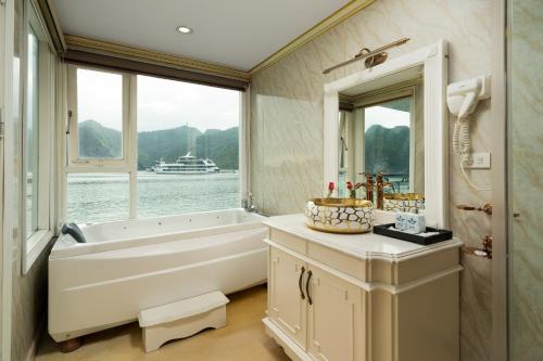 下龙湾La Renta Premium Cruise的带浴缸、水槽和镜子的浴室