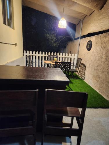 SiguatepequeLa casa de la Gaviota的一间设有桌椅的用餐室,并铺有绿色的地板