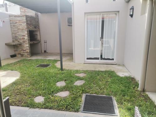 杜拉斯诺MANDALA HOME的门前有草地和石头的庭院
