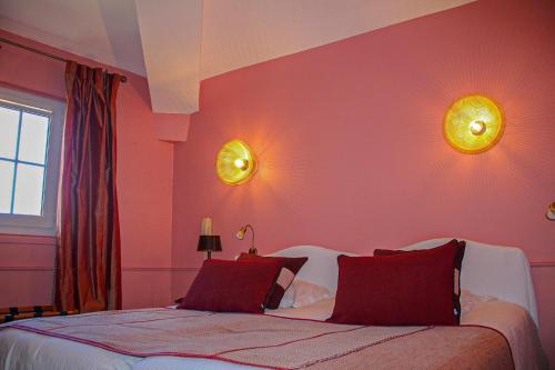 蒙彼利埃宫殿酒店的卧室配有一张床,墙上有两盏灯